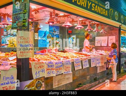 GRANADA, SPAIN - SEPT 27, 2019: The counter of the stall with fresh seafood and prices, Mercado San Agustin market, on Sept 27 in Granada Stock Photo