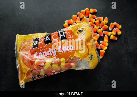 Moscow, Russia, September 2021: Candy corn Brachs spilled out of the pack. Halloween sweets. Copy space. Stock Photo