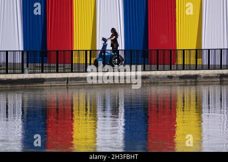 Santiago, Metropolitana, Chile. 28th Oct, 2021. A woman rides an electric scooter through the Parque de la Familia, intervened with several works as part of the Made at Home Fest, in Santiago de Chile. (Credit Image: © Matias Basualdo/ZUMA Press Wire) Credit: ZUMA Press, Inc./Alamy Live News Stock Photo