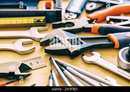 Workshop bench. DIY, maintenance service works flat lay. Home repair tools set on wooden background. Stock Photo