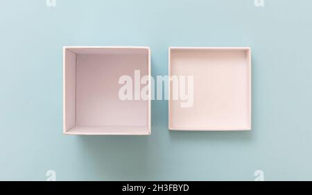 Gift box white empty, open cover on pastel blue background, top view. Blank space, branding template, product presentation Stock Photo