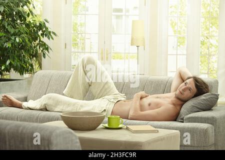 Young man resting on couch Stock Photo