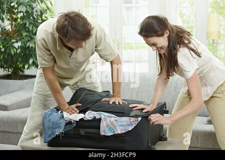 Closing suitcase Stock Photo