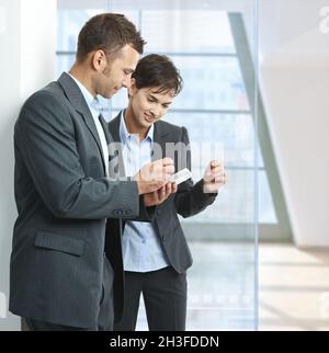 Businesspeople using mobile Stock Photo