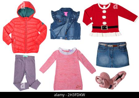 Collage set of clothes for a little girl isolated on a white background. The collection of a jeans vest and skirt, a sweater in Santa Claus design, dr Stock Photo