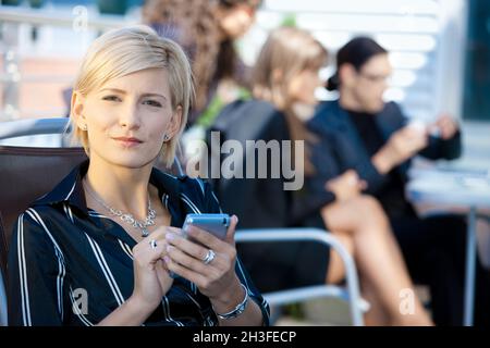 Businesswoman using smart phone Stock Photo