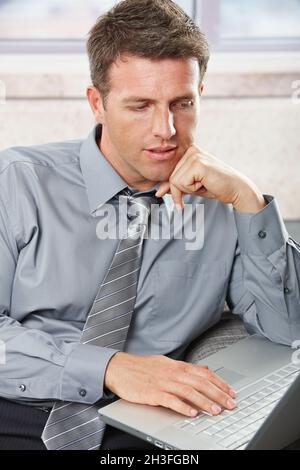 Professional looking down at computer Stock Photo