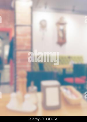 A blurry image Vintage cafe interior can be used as a background. . An old-fashioned chiming clock hangs on the wall. Stock Photo