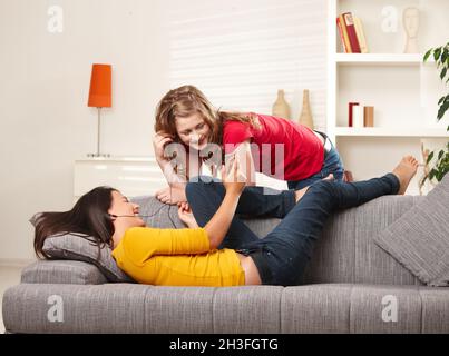 Smiling girls listening to music Stock Photo