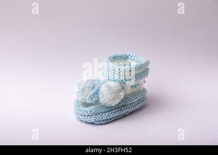 homemade knitted shoes for newborn boys on white background Stock Photo