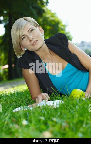 Woman reading book outdoor Stock Photo