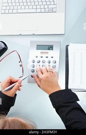 Female hands using calculator Stock Photo