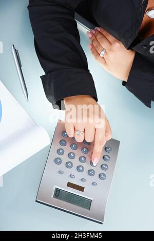 Female hands using calculator Stock Photo