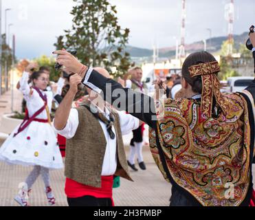 Dance and traditional costumes from the province of La Rioja, Spain. Detail of the costume and hairstyle of the dancer from behind with castanets in h Stock Photo