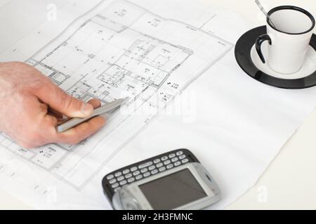 Floor plan on architect's desk Stock Photo