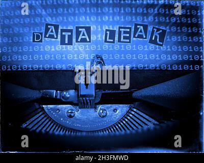 Data Leak displayed on a Mechanical Typewriter with a Binary code background and a Blue tone, Vintage distorted look, Ransom note typography Stock Photo