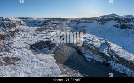 Hafragilsfoss waterfall with snow in autumn aerial view, Iceland Stock Photo