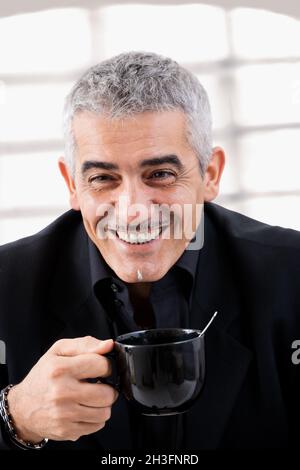 Businessman drinking tea Stock Photo