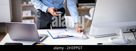 Stealing Trade Secret. Taking Photo Using Phone At Desk Stock Photo
