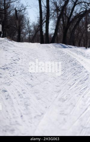 Winter landscape. Road is covered with lot of white snow after blizzard, forest with road Stock Photo