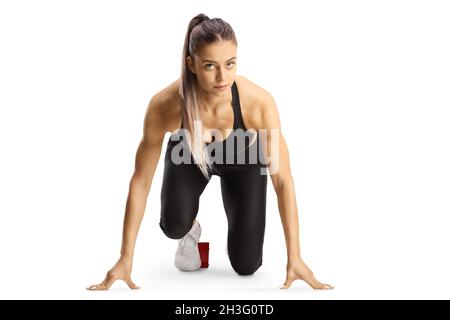 Young female runner in a crouch start position isolated on white background Stock Photo