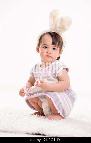 Baby girl with bunny ears Stock Photo