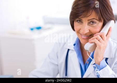 Doctor calling on phone Stock Photo