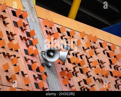 Speakers with a Pigeon Standing on an Orange Ceiling Stock Photo