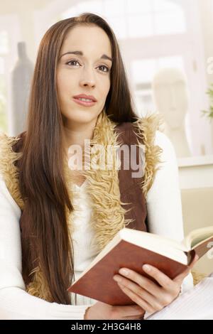 Young woman daydreaming at home Stock Photo