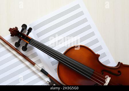 Nice violin and open blank music book on white wooden background Stock Photo