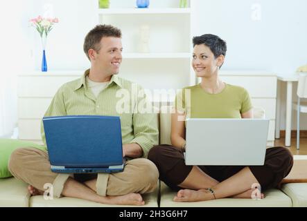 Happy couple using computer Stock Photo