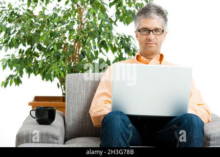 Man using laptop at home Stock Photo