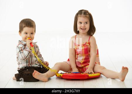 Little children playing with toy instrument Stock Photo