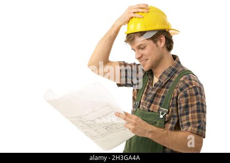 Young builder looking at floor plan Stock Photo