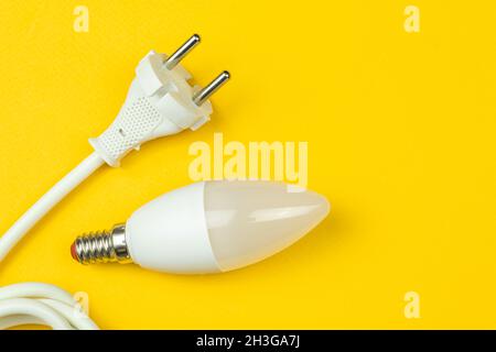 Energy efficiency with LED light bulb and electrical power cable with EU plug. Energy saving concept photo Stock Photo
