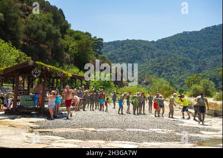 DALYAN, TURKEY-JUNE 21, 2018: Tourists enjoy mud baths near the town of Dalyan, Mugla Province. Stock Photo