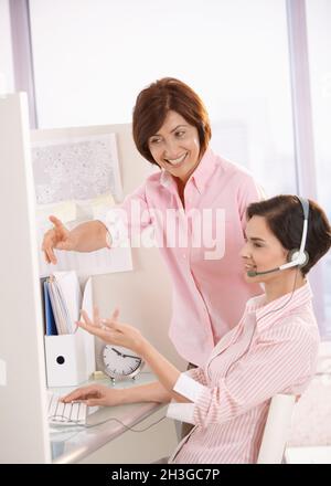 Smiling coworkers discussing work in office Stock Photo