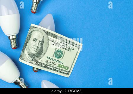 LED light bulbs and money, dollar bills. Energy savings, energy efficiency concept Stock Photo