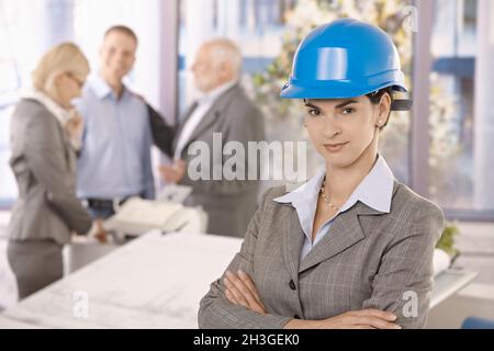 Confident female architect wearing hardhat Stock Photo