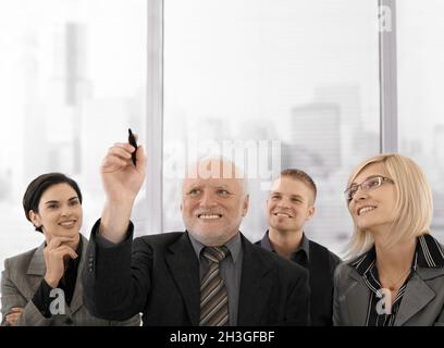 Senior businessman drawing with marker pen Stock Photo