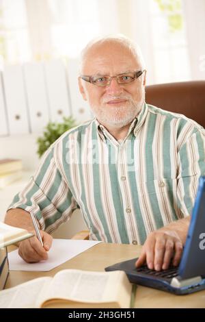 Senior professor working in his study Stock Photo