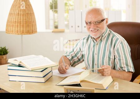 Elderly professor working in his study Stock Photo
