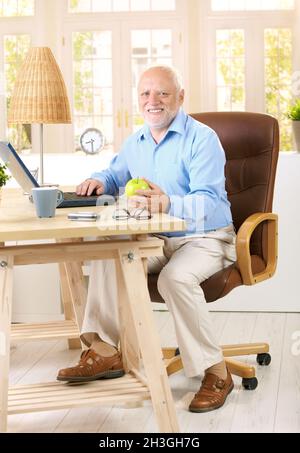 Older man working in his study Stock Photo
