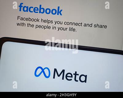 hand holding a mobile phone showing meta logo Stock Photo