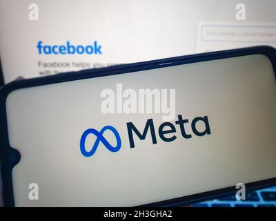 hand holding a mobile phone showing meta logo Stock Photo