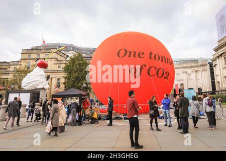 Trafalgar Square, London, UK. 28th Oct, 2021. A large orange 'Carbon Bubble' representing one tonne of CO2 has been installed on Trafalgar Square by the City of Westminster in collaboration with PWC, to raise awareness of climate change in the run up to COP26. Credit: Imageplotter/Alamy Live News Stock Photo