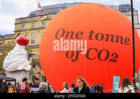 Trafalgar Square, London, UK. 28th Oct, 2021. A large orange 'Carbon Bubble' representing one tonne of CO2 has been installed on Trafalgar Square by the City of Westminster in collaboration with PWC, to raise awareness of climate change in the run up to COP26. Credit: Imageplotter/Alamy Live News Stock Photo