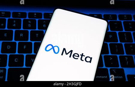 Facebook META company logo seen smartphone which is placed on laptop keyboard. META is a new rebranded Facebook Inc logotype. Stafford, Unided Kingdom Stock Photo