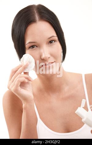 Beautiful young woman cleaning face Stock Photo