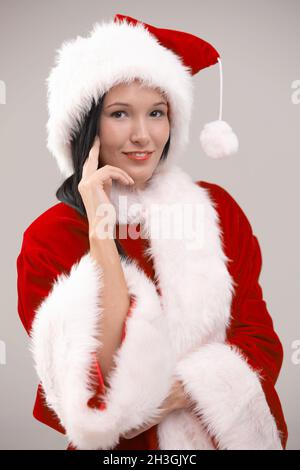 Portrait of young woman wearing santa costume Stock Photo